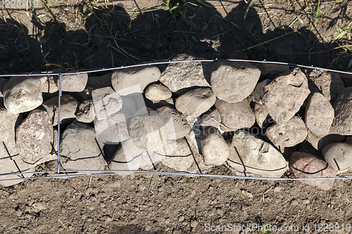 Image of metal mesh and stones