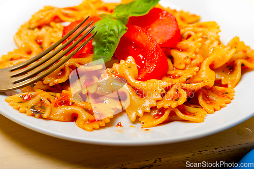 Image of Italian pasta farfalle butterfly bow-tie and tomato sauce