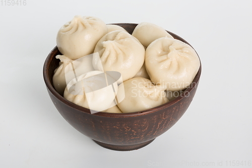 Image of Georgian dumplings Khinkali with meat on metal plate close-up