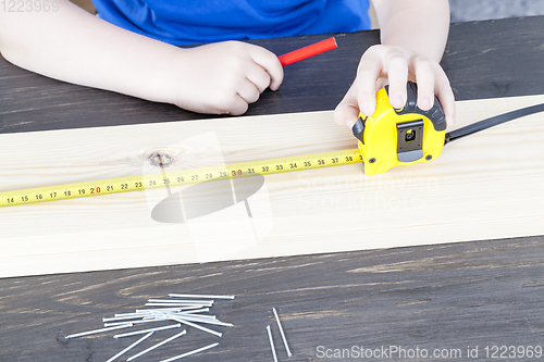 Image of a small boy is building