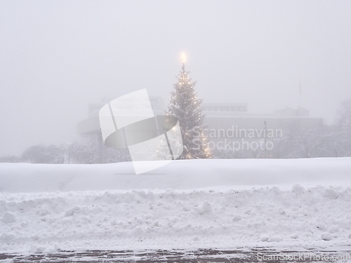 Image of christmas tree on a foggy day in a small finnish town