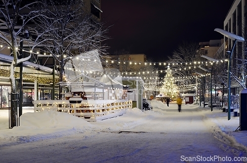 Image of christmas lights and christmas tree in the snowy town 