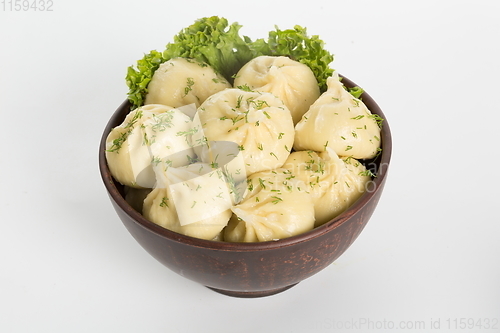 Image of Georgian dumplings Khinkali with meat on metal plate close-up