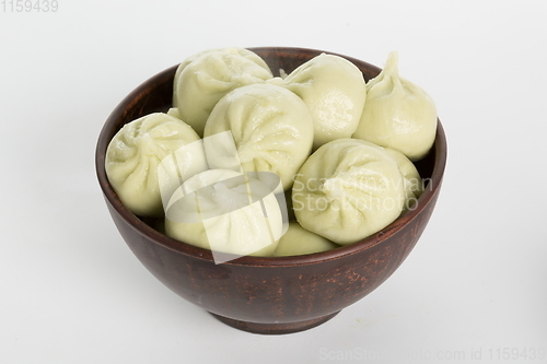 Image of Georgian dumplings Khinkali with meat on metal plate close-up