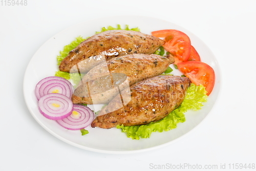 Image of Three fried breaded cutlet with lettuce, tomatoes, cucumbers and onion on white background