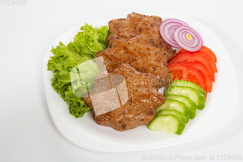 Image of Three fried breaded cutlet with lettuce, tomatoes, cucumbers and onion on white background