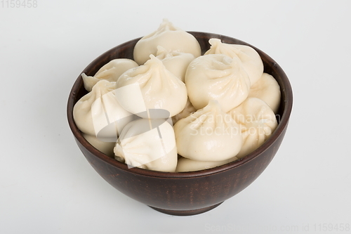 Image of Georgian dumplings Khinkali with meat on metal plate close-up