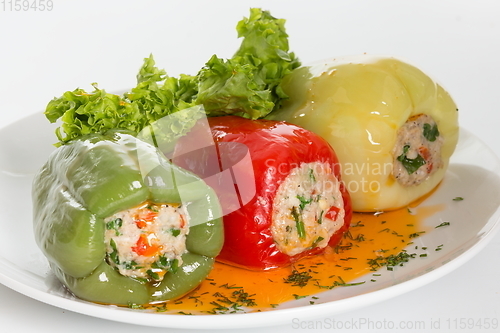 Image of Colorful baked with cheese, stuffed peppers with rice and minced meat. Front view.