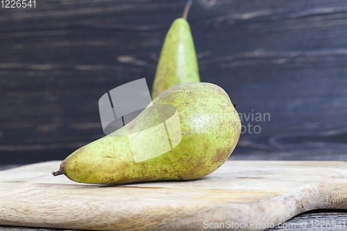 Image of two old green pears