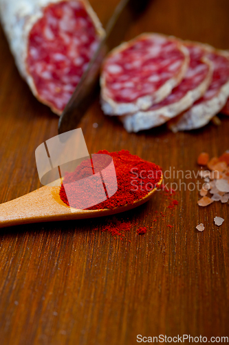 Image of traditional Italian salame cured sausage sliced on a wood board