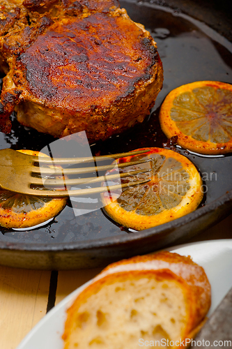 Image of pork chop seared on iron skillet