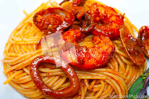 Image of Italian seafood spaghetti pasta on red tomato sauce