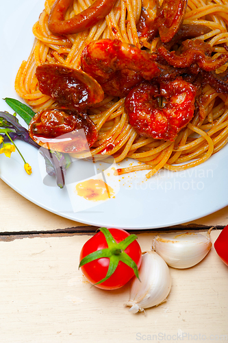 Image of Italian seafood spaghetti pasta on red tomato sauce