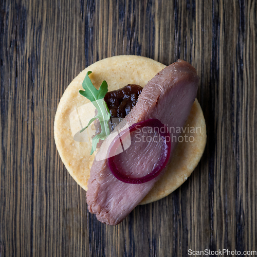 Image of cookie with roasted duck fillet and red onion jam