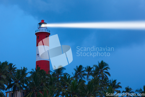 Image of Lighthouse in night with light beam