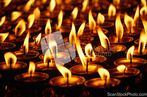 Image of Burning candles in Buddhist temple. Dharamsala, Himachal Pradesh
