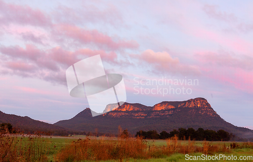 Image of Rocky mountain wilderness with soft pinky orange sky