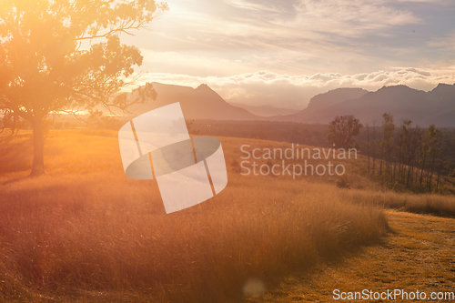 Image of Sunlight bursting through the valley across the landscape