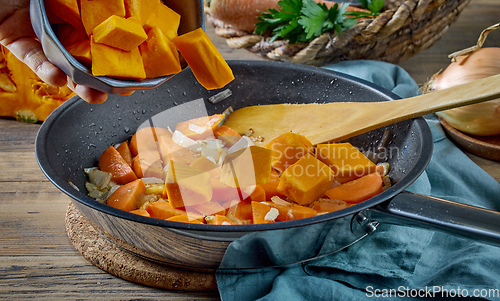 Image of fresh sliced pumpkin on frying pan