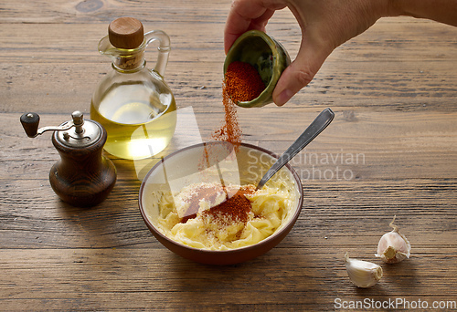 Image of adding paprika powder to garlic butter