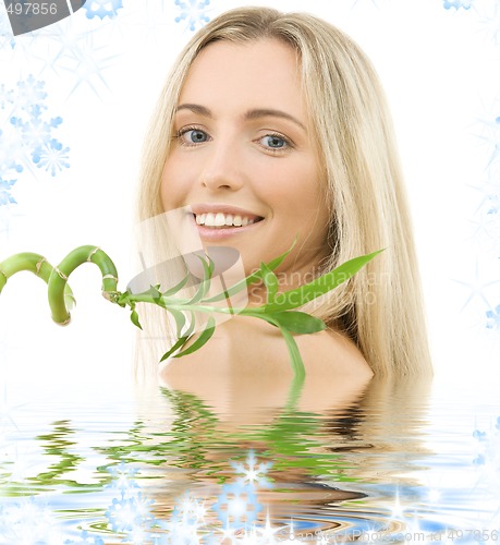 Image of happy blonde with bamboo