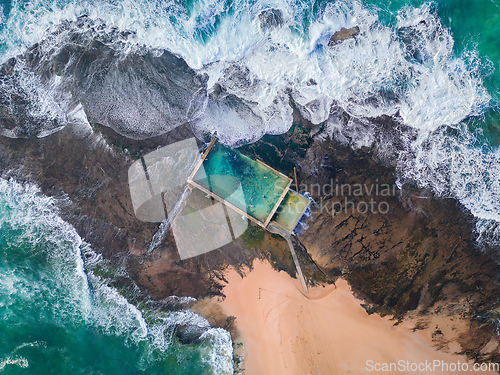 Image of Tidal swimming pool built on a rock shelf surrounded by ocean