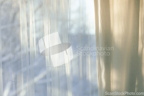 Image of curtains hang in front of window