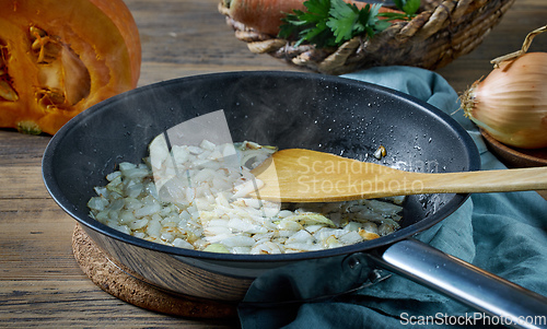 Image of sliced sweet onion on frying pan