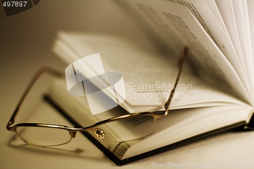Image of opened book and glasses