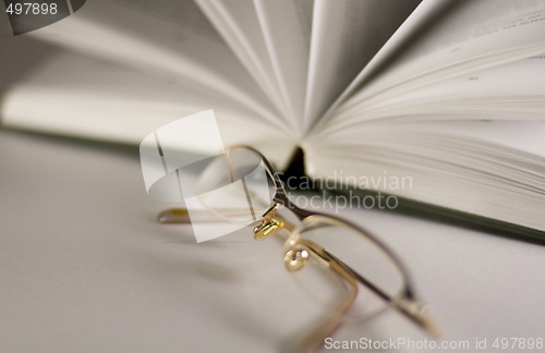 Image of opened book and glasses