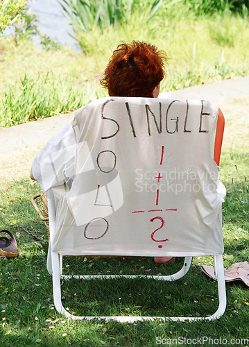 Image of Female sitting outside.