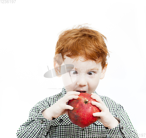 Image of boy eats pomegranate