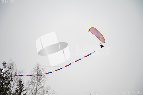 Image of Paraglider is flying in the sky