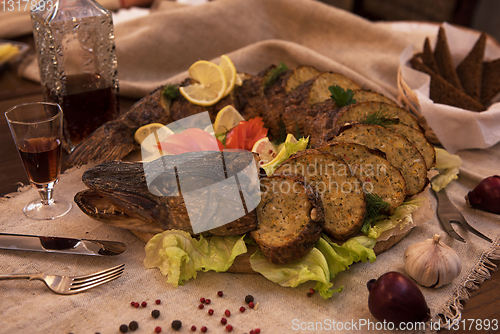 Image of Stuffed pike with vegetables and greens.