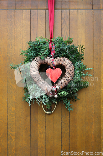 Image of Traditional christmas wreath on a wooden door