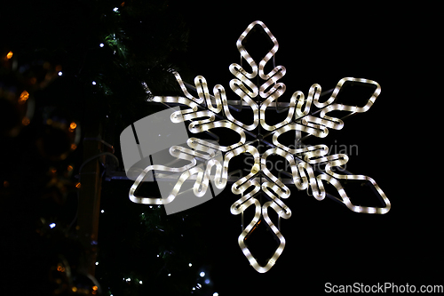 Image of Beautiful christmas decoration, bright glowing neon snowflake