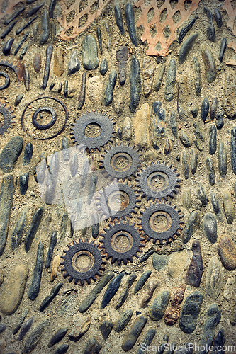 Image of Unusual floor with pattern from pebbles and metal details