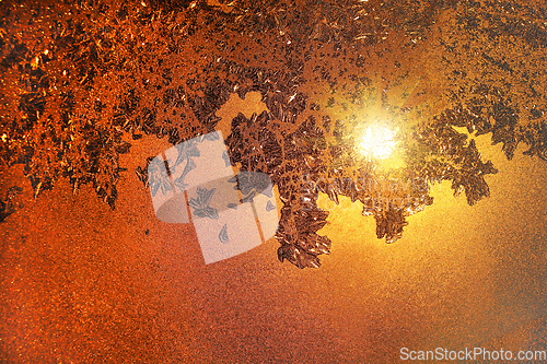 Image of Ice pattern and sunlight on morning winter glass