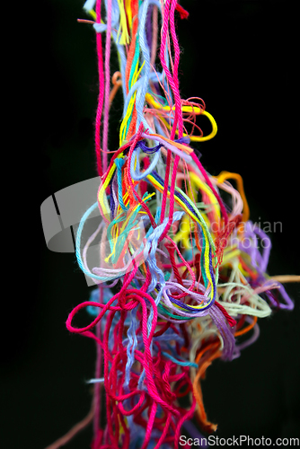 Image of Multicolored tangled threads for needlework on black background