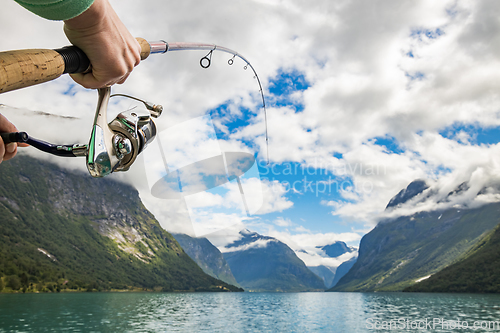 Image of Woman fishing on Fishing rod spinning in Norway.