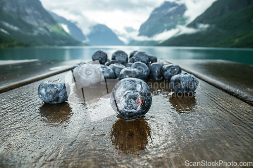 Image of Blueberry antioxidants on a wooden table on a background of Norw