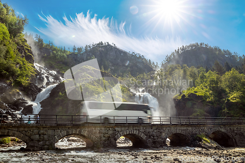 Image of Tourist bus traveling on the road Latefossen Waterfall Odda Norw