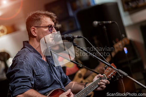 Image of Band performs on stage, rock music concert.