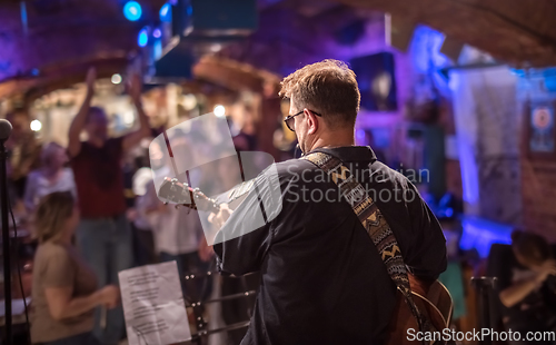 Image of Band performs on stage, rock music concert.