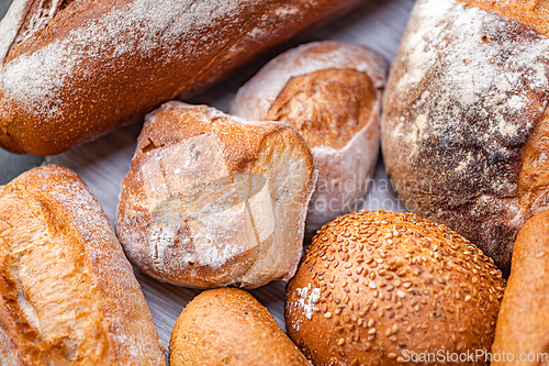 Image of Freshly baked natural bread is on the kitchen table.