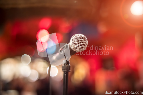 Image of Microphone on stage against a background of auditorium.