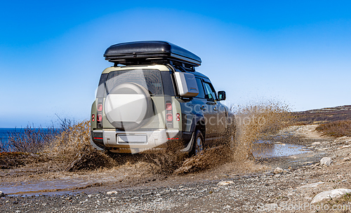 Image of Off road tourist car rides off-road in the highlands. Expedition