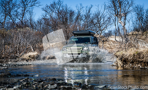 Image of Off road tourist car rides off-road in the highlands. Expedition