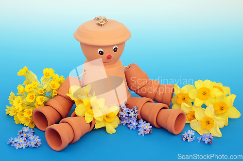 Image of Recycled Fun Flower Pot Man Garden Ornament and Spring Flowers