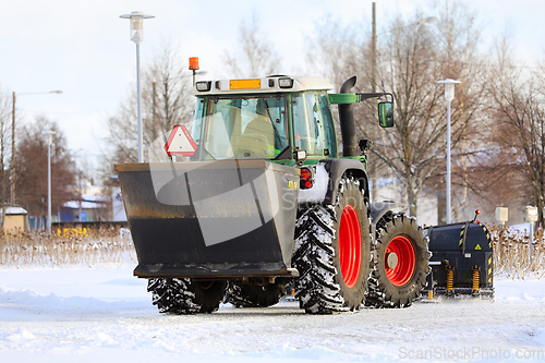 Image of Tractor Spreading Grit and Ploughing Snow